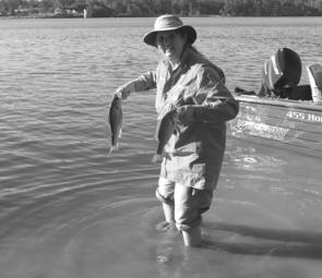 Sue Fleming releasing a pair of Australian bass after the Noosa Water Festival. 